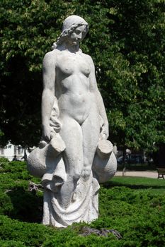 White statue of woman in the city park