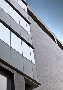 Detail of the facade office building close up. Stained-glass system and hinged front panel.