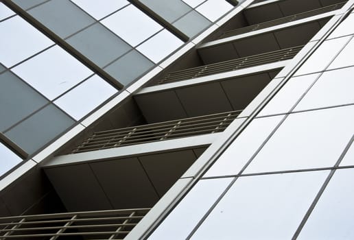 Detail of the facade office building close up. Stained-glass system and hinged front panel.