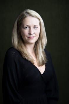 Portrait of pretty blonde woman on a dark background