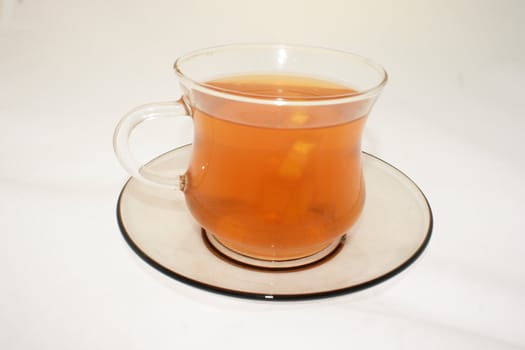 small cup with hot red tea and lemon
