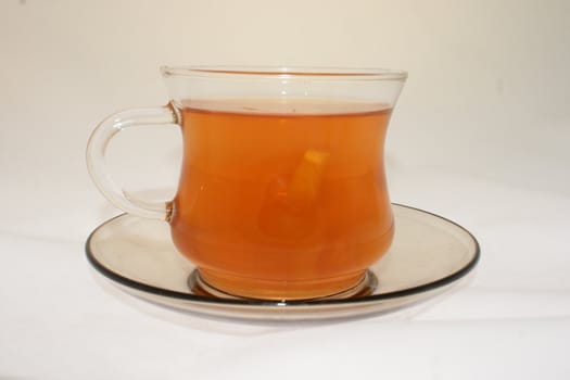 small cup with hot red tea and lemon