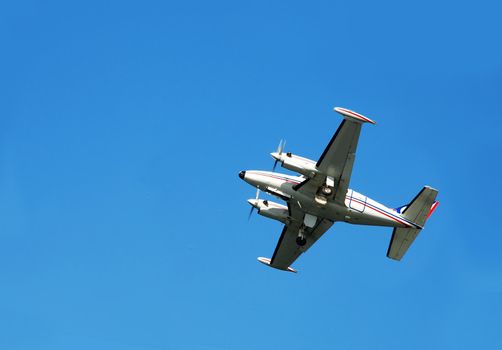 passenger airplane flying over blue sky isolated
