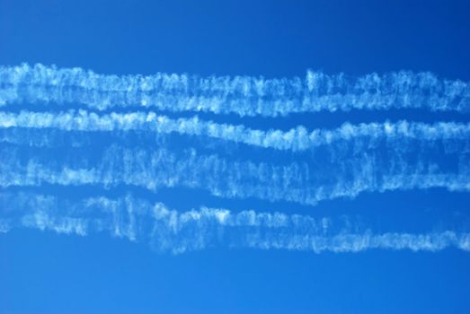 traces in blue sky after acrobatic flight