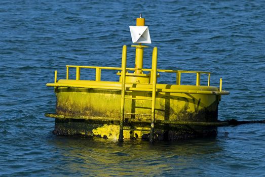 Yellow buoy on a blue water

