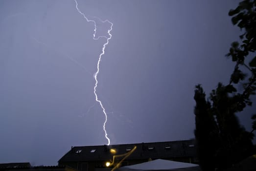 A thunderstorm advances above house roofs in the Netherlands