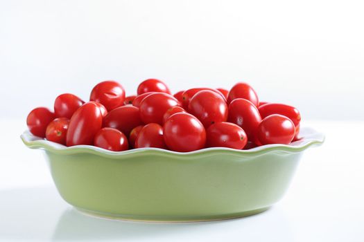 grape tomatoes in a bowl on white