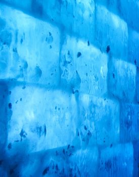 Wall of ice bricks with blue back light