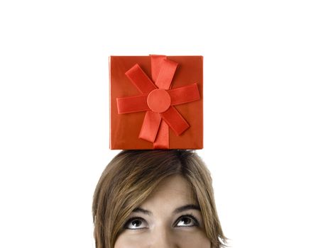 Portrait of a young woman holding a gift isolated on white background