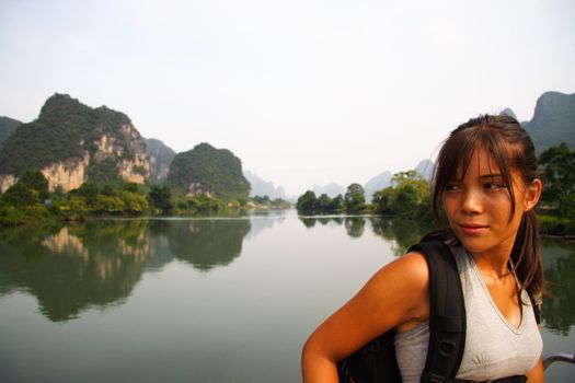 Young woman enjoying the scenery during a hike in Yangshuo, China