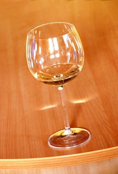 Wine glass with wine on orange wood background