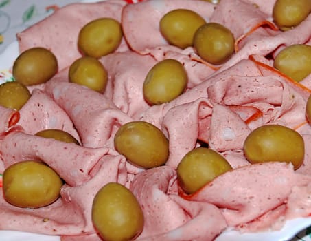 pink ham slices decorated with green olives