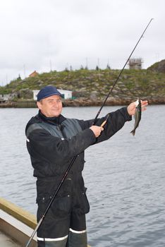 The fisherman on the pier on island Skrova