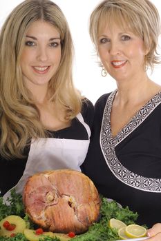 mother and daughter cooking ham together
