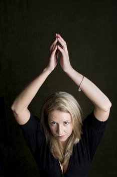 Pretty blonde woman holding her hands above her head