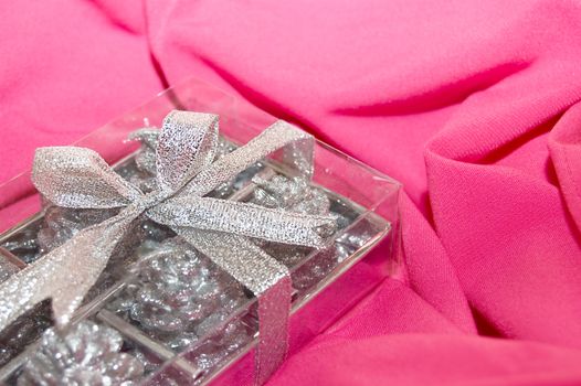 silver gift box over pink fabric