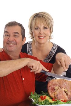 couple carving a ham