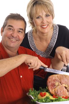 beautiful couple slicing ham