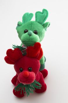 red and green toy reindeer standing one on top of the other