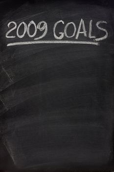 2009 goals title handwritten with white chalk on blackboard with copy space below for New Year tasks and resolutions