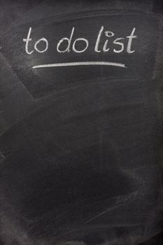 to do list title handritten with white chalk on blackboard with copy space below