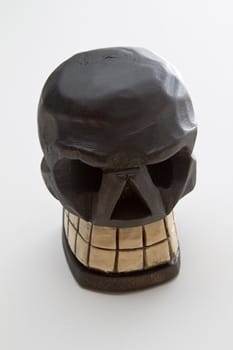 Mexican Dia de los muertos skull sculpture in wood