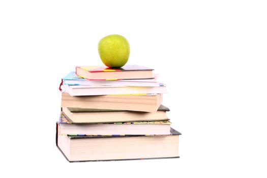 group of books with green apple on the top looking like pyramid isolated over white
