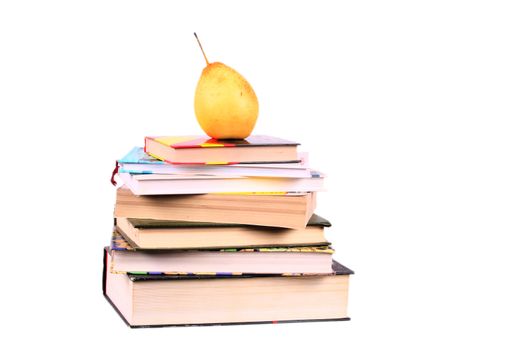 group of books with yellow pear on the top looking like pyramid isolated over white