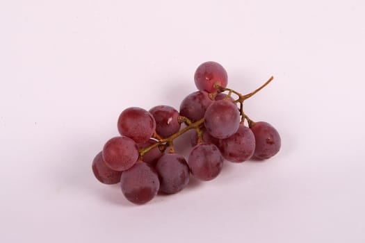 small bunch of black grape over white background