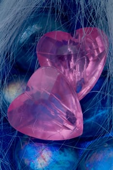 The pink crystal heart lie on the color glasses