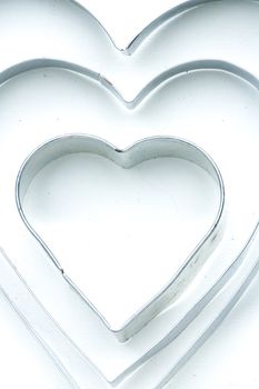 The white aluminum hearts lie one in one