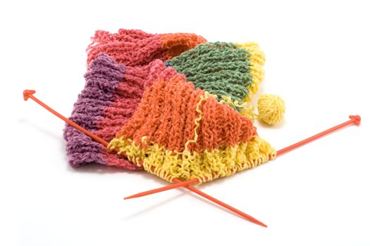 Knitted colour scarf, wool, spokes on white background