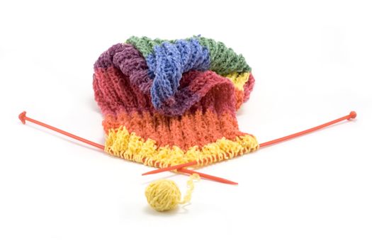 Knitted colour scarf, wool, spokes on white background