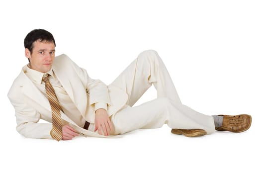 A handsome young man in a suit lying on a white background