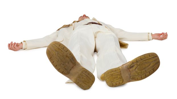 A man in a light suit lying on the floor