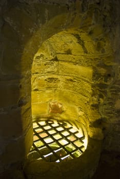 old well illuminated from below inside a palace