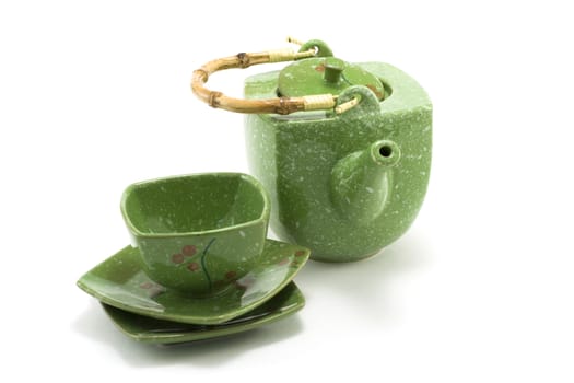 Chinese teapot with bamboo handle and cup insulated on white background