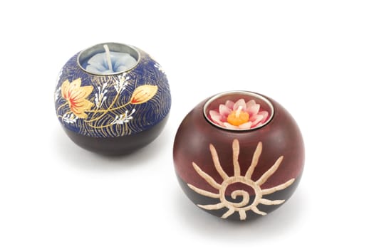Two candlesticks, wooden balls with candle on white background