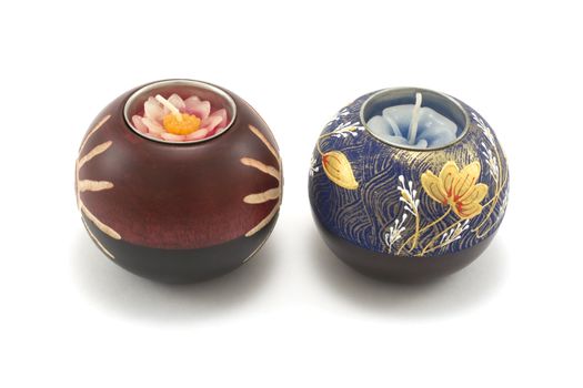 Two candlesticks, wooden balls with candle on white background