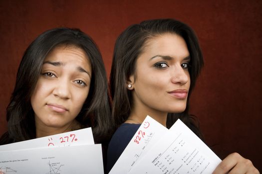 Two girls with conrasting scores on school tests