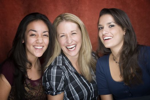 Three pretty women laughing in a studio setting