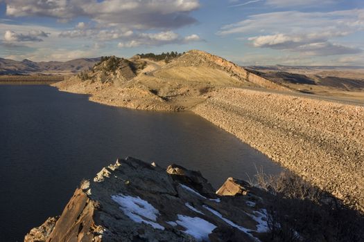 two rock dams of Horsetooth Reservoir and Centennial Road at foothills of Rocky Mountains in Colorado near Fort Collins
