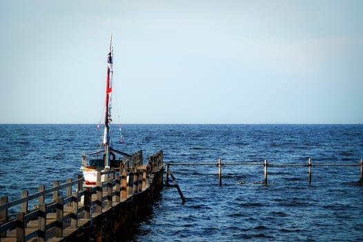 A scenic view of bridge, sea, and boat