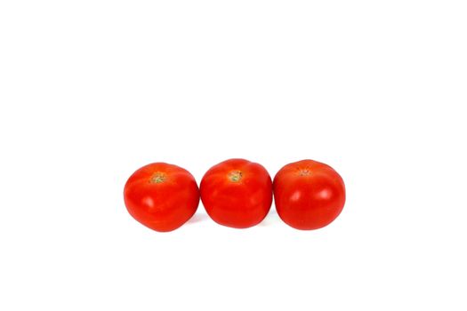 group of three red tomatos isolated over white