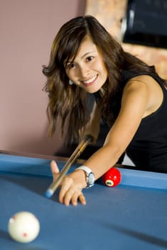 pretty asian woman playing pool