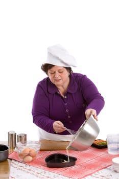 Chef pouring a mixture into a baking tray