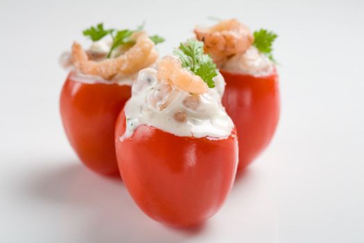 Small cherry tomatoes filled with shrimp cocktail