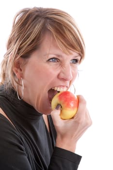 Pretty blond girl biting in an apple