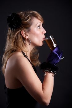 Pretty blond woman taking a sip from her glass