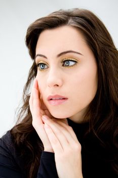 Face of a beautiful blue eyed brunette, isolated